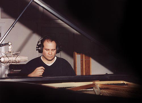 Joseph Bertolozzi in the studio at the piano. Image © 2002, Rennie Pomatti